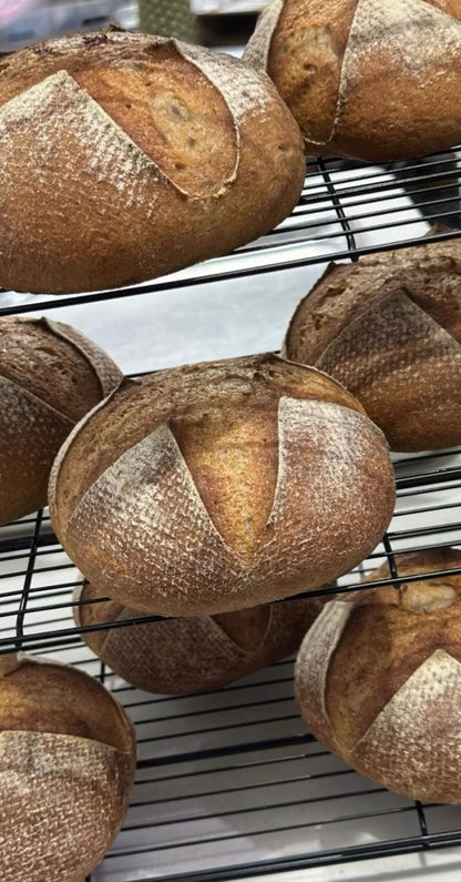 Loaves of bread on a cooling rack with a blurred background